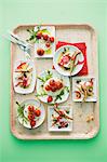 Two different mozzarella dishes on a tray