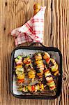 Salmon and potatoes skewers with peppers and courgettes