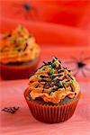 Chocolate cupcakes with orange buttercream and sugar sprinkles for Halloween