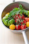 Various fresh tomatoes in a saucepan