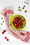 Fresh cherries in a green colander