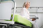 Patient in hospital sitting on bed
