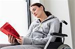 Sad woman sitting in wheelchair