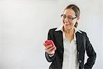 Businesswoman in black suit with smart phone, smiling
