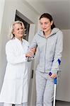 Patient with crutches prcticing to walk