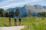 three mountain bikers on the way, Matajur, Istria, Slovenia