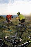 two mountain bikers repairing bicycle tyre, Vipava valley, Istria, Slovenia