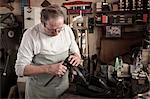 Cobbler working in workshop