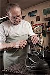 Cobbler working in workshop