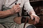 Cobbler working in workshop, close-up