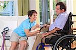 Couple with Cerebral Palsy looking at a digital tablet