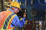 Engineer in electric power plant reviewing sensor readings