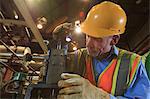 Engineer in electric power plant inspecting a electrically controlled valve