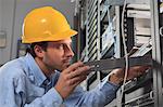 Network engineer installing equipment slide in rack