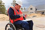 Construction engineer with spinal cord injury adjusting vise tool on site