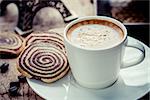 Cup of espresso and biscotti on table