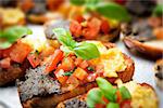 italian bruschetta with tomatoes, olive paste on a serving plate