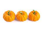 Row of decorative orange pumpkins, isolated on white background, top view