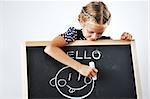 Smiling cute little girl being pacient with her drawings