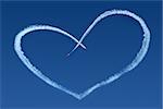 Airplanes Skywriting a Heart on blue sky