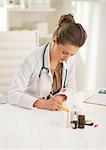 Doctor woman writing in prescription