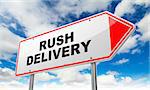 Rush Delivery - Inscription on Red Road Sign on Sky Background.