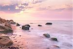 Sunrise landscape over beautiful rocky coastline in the Sea with sunbeams