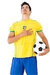 Brazilian football player in yellow listening to anthem over white background