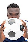 Close up portrait of a serious football player over white background