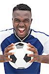 Portrait of a football player shouting over white background