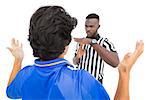 Serious referee showing time out sign to player over white background