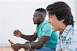 Side view of two excited soccer fans over white background