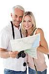 Portrait of happy mature couple looking at map on white background