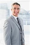 Businessman smiling at the camera from his workplace