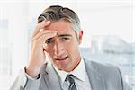 Businessman suffering from a headache at work