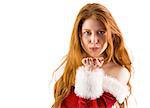Festive redhead blowing a kiss on white background