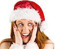 Festive redhead with hands on face on white background