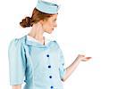 Pretty air hostess presenting with hand on white background