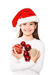 Festive little girl smiling at camera holding baubles on white background