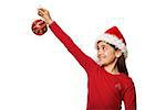 Festive little girl hanging a christmas decoration on white background