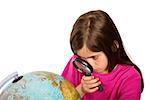 Cute pupil looking at globe through magnifying glass on white background