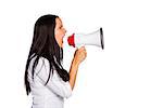 Young woman shouting through megaphone on white background