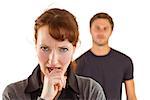 Worried woman with man behind on white background