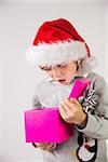 Child opening his christmas present on white background