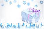 Snowflakes and fir trees against blue gift box with purple ribbon
