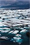 Senic view of glacial ice and lake water with mountains in background, Jokulsarlon, Iceland