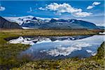 Scenic view of mountains reflected in glacial lake, Svinafellsjokull, Skaftafell National Park, Iceland
