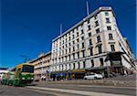 Tram on street and the Adams Building, Design District Helsinki, Helsinki, Finland