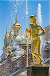 Close-up of a golden statue and the Grand Cascade with Church in background, Peterhof Palace, St. Petersburg, Russia