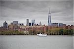 New York City Skyline with One World Trade Center and Tour Boat on East River, New York, USA